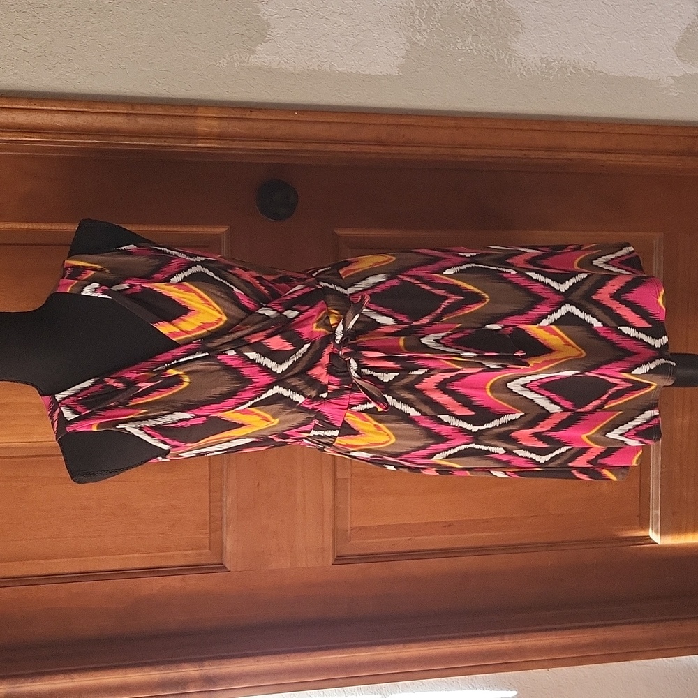 Multi-colored criss-cross front style pleated dress with elastic waistband.